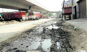 A road under the elevated road in poor condition in Amritsar.