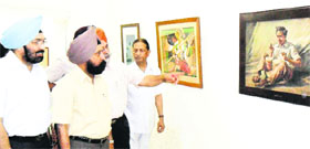 AS Brar, Vice Chancellor, Guru Nanak Dev University, takes a look at paintings during an exhibition at the art gallery in Amritsar on Sunday.