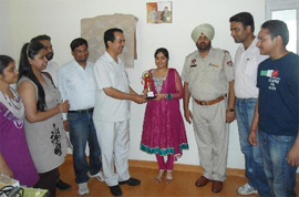 Navdeep Kaur,a BCA first batch student of the Punjabi Universitys Maur campus in Bathinda, being felicitated by the principal Dr DK Madaan.