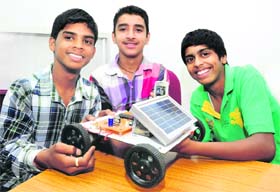 Students of the Sector-25 school, (from left) Abhishek, Prince and Vikram, with their mobile-operated solar car in Chandigarh on Sunday