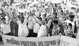 Primary assistant teachers hold a protest march in Mandi on Sunday.