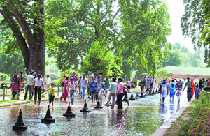 Hordes of tourists as well as locals cool off near the fountains in the Mughal Garden in Srinagar on Sunday as the entire state reels under an intense heat wave.