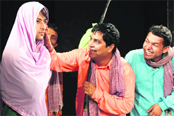 Artistes enact a play at Natrang theatre in Jammu. 