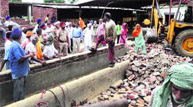Rescue operation in progress to extricate animals trapped under debris in Nussi village on Sunday.