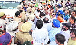 Shopkeepers at the car bazaar argue with the police and MC officials after they were stopped from parking their vehicles near Preet Palace in Ludhiana on Sunday