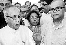 UPA presidential candidate Pranab Mukherjee interacts with the media on his arrival at the NSCBI Airport in Kolkata on Sunday
