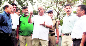 Sports Minister Dinesh Aggarwal gives directions to officials during his visit to the Parade Ground in Dehradun on Monday.