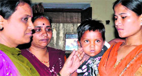 Sangeeta (3), who was kidnapped from Mumbai, being handed over to Mumbai police personnel in Haridwar on Monday.