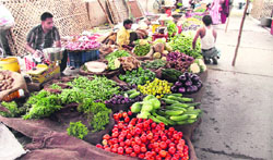 Vegetable vendors at Azad Sabzi Mandi sell vegetables by sitting on the floor