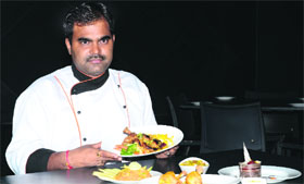 A chef displays mango dishes during the Mango Sutra festival in Ludhiana.