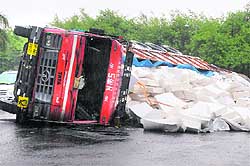 A loaded truck overturns on the road separating Sectors 4 and 5 during rain at Panchkula on Tuesday