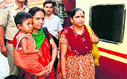 Three-year-old Sangeeta being taken to Mumbai by police personnel in Haridwar on Tuesday
