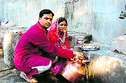 A newly wed couple worshipping a natural water resource in the Narendranagar region of Tehri district as part of Dhaar puja ritual