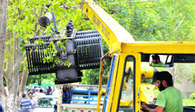 Employees of the Power Development Department replace a transformer in Jammu.