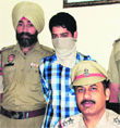 Sarvan Kumar, from whom two stolen bikes were recovered, in police custody in Jalandhar on Tuesday. A Tribune photograph