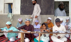 Mohammad Ghulam Ashraf Misbahi (inset) and a class in progress at the Jame Ashraf Baba Haji Rattan Islamia School in Awa Basti in Bathinda. tribune photographs