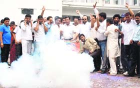 Congress workers celebrate the victory of Chief Minister Vijay Bahuguna in the Sitarganj bypoll by bursting crackers at Congress Bhavan in Dehradun on Wednesday