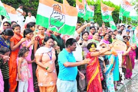 Congress and Uttarakhand Kranti Dal activists offer milk to the Ganga to celebrate Vijay Bahugunas victory in Haridwar on Wednesday