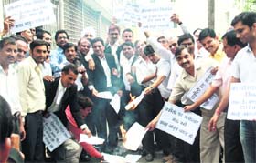 Protesting lawyers burn the copies of the proposed Bills in Dehradun on Wednesday