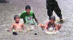A group of children splash in the rainwater at Bhadaur House in Ludhiana on Wednesday