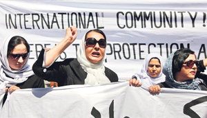 Women take out a protest march in Kabul against the recent public execution of a women on Wednesday. The 22-year-old was shot dead as dozens of men cheered in a village about 100 km north of the capital.