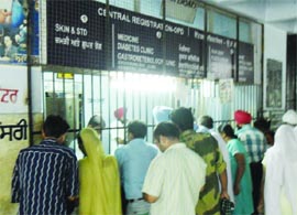 People outside the OPD slip counter at Guru Nanak Dev Hospital in Amritsar on Thursday.
