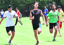 Athletes take part in a 100m race at the Chandigarh State Sub-Junior and Junior Athletics Championship in Chandigarh on Thursday. 