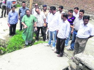 Dehradun Mayor Vinod Chamoli (in green kurta) inspects the drainage of the Race Course ward in Dehradun on Thursday. 
