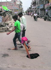 A view of the spot where the part of a road caved in at the Bal Singh Nagar in Ludhiana
