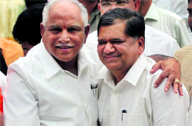 Newly sworn-in Karnataka Chief Minister Jagadish Shettar (R) with BS Yeddyurappa at the Raj Bhawan in Bangalore on Thursday.