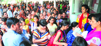 Students stand in a queue to deposit admission fee at the GCG, Sector 11, in Chandigarh on Friday. 
