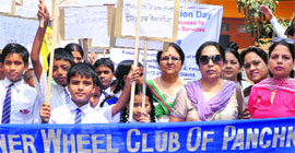 Members of the Inner Wheel Club in collaboration with the FPA India take part in a rally to mark the World Population Day at Panchkula on Friday.