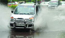 The rains turn Delhi roads into virtual pools. Tribune photo: Manas Ranjan Bhui