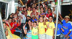 Cancer-afflicted children and their family members enjoy a metro ride in New Delhi on Friday. Tribune photo