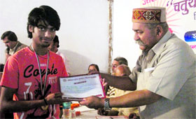 Former Mussoorie MLA Jot Singh Gunsola presents citation and award to a student in Mussoorie on Friday.