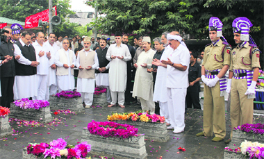 Chief Minister Omar Abdullah along with National Conference and Congress leaders offers prayers during the ceremony marking Martyrs Day in Srinagar on Friday.