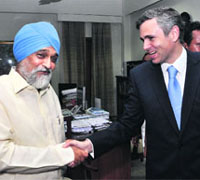 Omar Abdullah with Montek Singh Ahluwalia in New Delhi on Friday. 