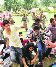 Protesting students being chased away by policemen at Barindra College in Faridkot on Friday. 