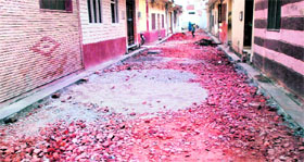 Carpeting work on a road left midway in Amritsar.