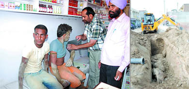 The two labourers, Raju and Mangat, being administered first aid at a local private clinic after they were rescued from under a pile of earth that fell on them while they were working in a sewer (right) in Lal Singh Basti in Bathinda on Saturday.  