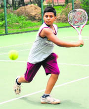 A player in action during a tennis match in Chandigarh on Saturday. 