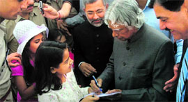 Former President APJ Abdul Kalam gives his autograph to a student at the Gaiety Theatre in Shimla on Saturday.
