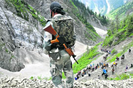 A security jawan stands guard on the Amarnath yatra route. 