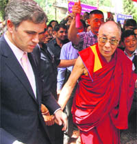 Tibetan spiritual leader the Dalai Lama and Chief Minister Omar Abdullah arrive at a school in Srinagar on Saturday. 