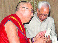 The Dalai Lama presents  books to Governor NN Vohra at Raj Bhawan in Srinagar on Saturday. 