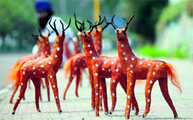 Deers made from jute on display for sale at a roadside in Jammu on Saturday.