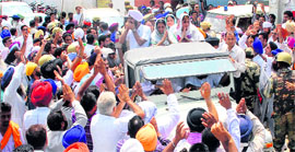 BJP candidate Sukhjit Kaur Sahi flanked by her son and daughter (in jeep) greet people during a victory rally in Dasuya.