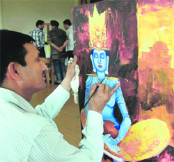 In the world of colours An artist gives final touches to his painting during a workshop at Virsa Vihar in Amritsar on Sunday.