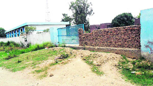 A brick wall stands in the place of an iron gate, which was stolen at partially built Mall Mandi bus stand. 