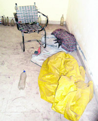Bottles of whiskey lie scattered in one of the rooms in the bus stand in Amritsar